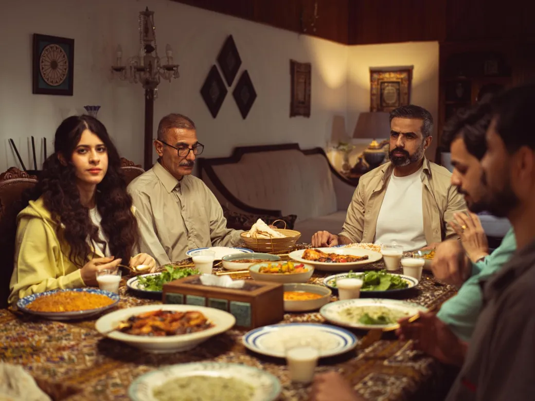 An Indian family sitting together at the dinner table at home