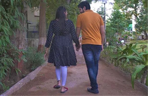 A young couple walking hand in hand