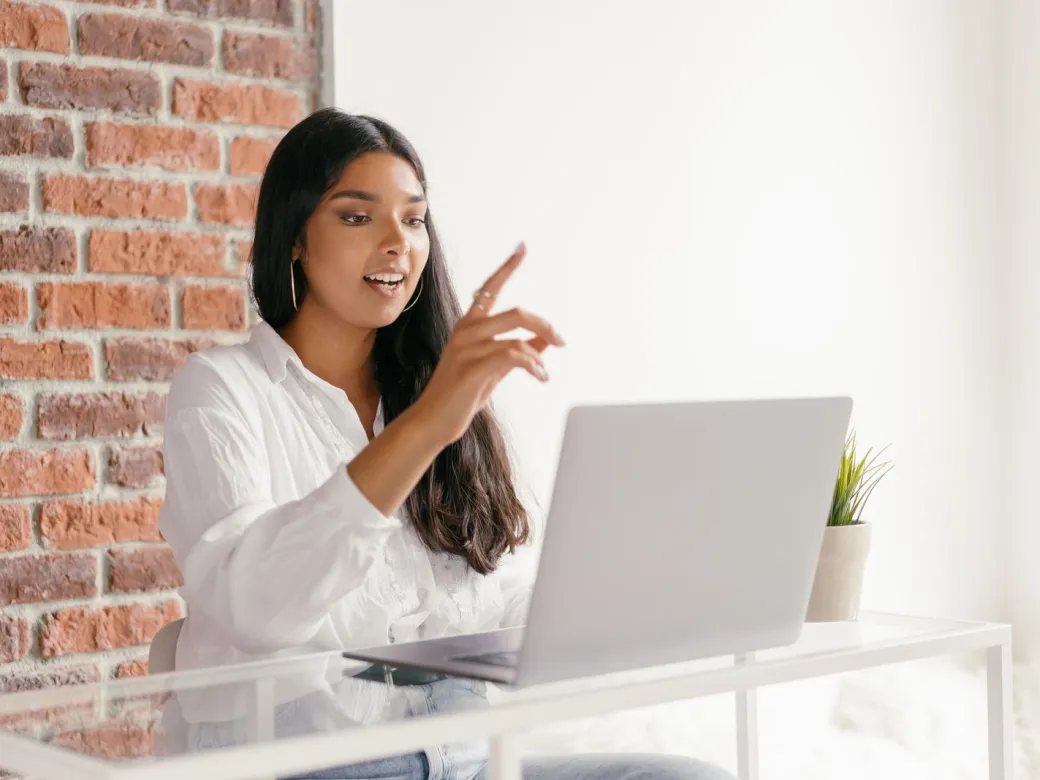 A woman in an online counseling session on her laptop