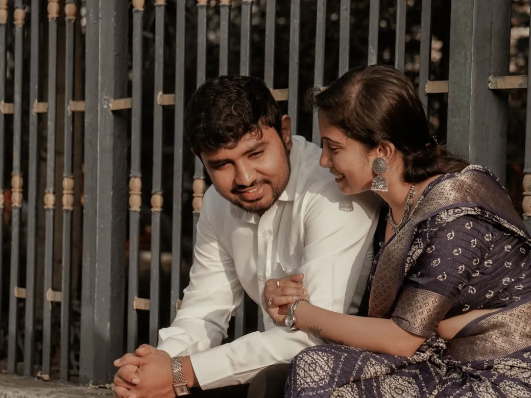 A young Indian couple in traditional clothes talking quietly